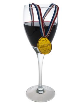 Glass with red wine with a medal winner