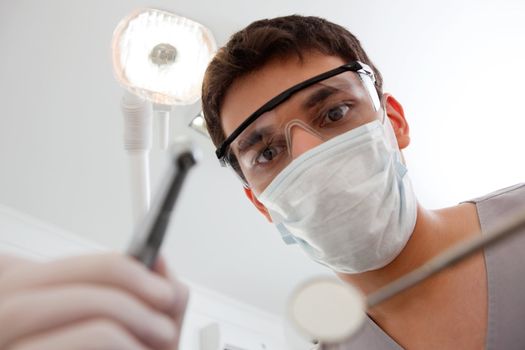 Dental technician with cleaning tools