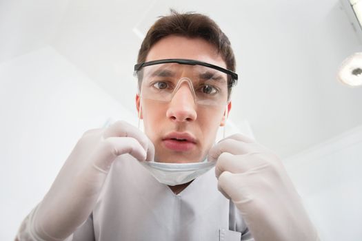 Close-up of young male dentist wearing mask