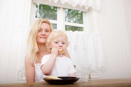 Portrait of a mother and son sitting at a table eating lunch together