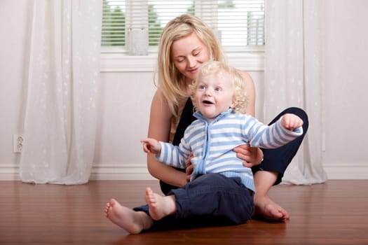 Boy and mother having fun at home