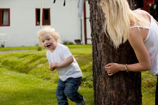 An extremely excited young boy looking for his mother playing hide and seek