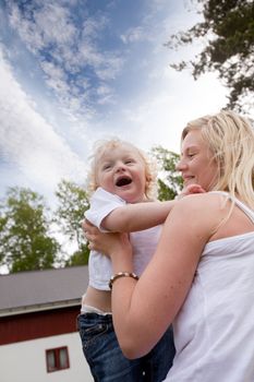 A mother and son spending time together outdoors in a rural setting