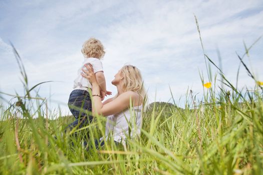 Baby boy and young mother looking at a view