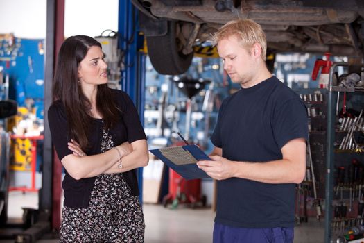An angry customer talking to a mechanic in an auto repair shop