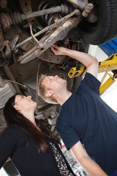 Mechanic showing female customer problems with car
