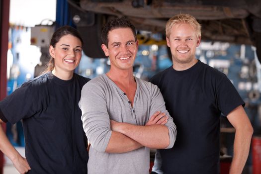 Portrait of a group of mechanics standing in a shop