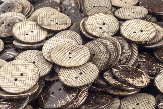 Garment buttons made from coconut closeup as background