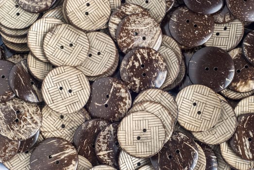 Garment buttons made from coconut closeup as background