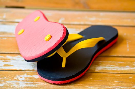 black and red slipper on wood