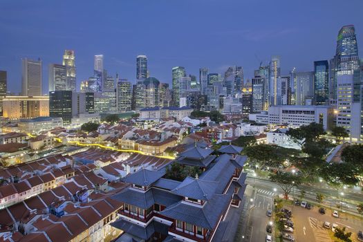 Singapore City Central Business District (CBD) Over Chinatown Area with Old Houses and Chinese Temple at Blue Hour
