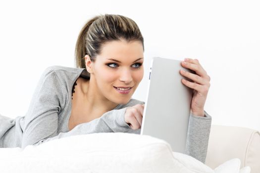 young woman on sofa with tablet at home