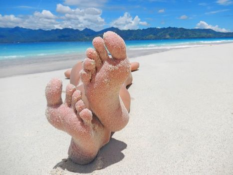 Sandy feet on a tropical beach                              