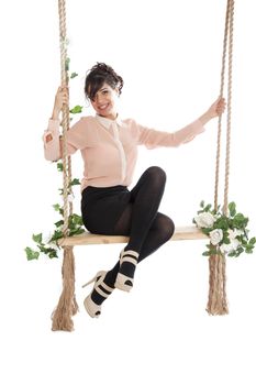 Emotional woman on a swing in the studio isolated background