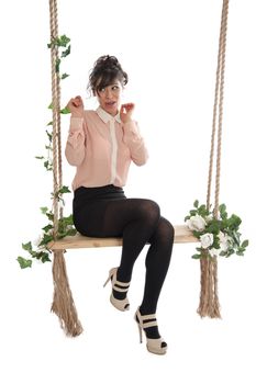 Emotional woman on a swing in the studio isolated background