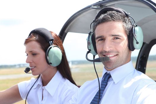 Man and woman in the cockpit of a light aircraft