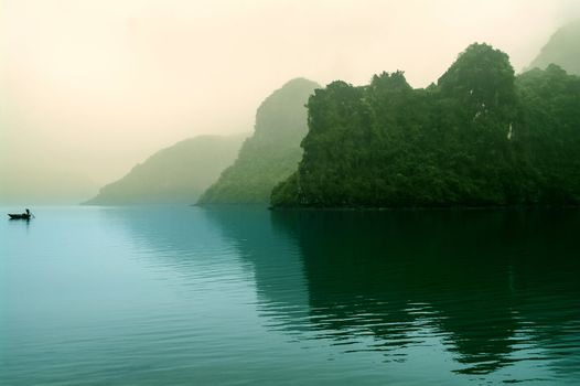The islands in morning mist. Halong Bay North Vietnam.