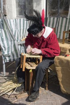 BRIELLE,HOLLAND APRIL 01:Man braids chair on April 01, 2013 in Brielle,Holland.This is the party of the point in the uprising of Low Countries against Spain in the 80 Years' War