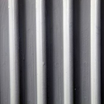 Close-up image of shades of black, white and grey wooded blinds.