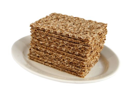 Sesame wholegrain crispbreads on porcelain plate isolated on white background