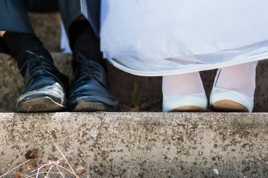 bride and groom in used wedding shoes. rest couple. close-up wedding shoes