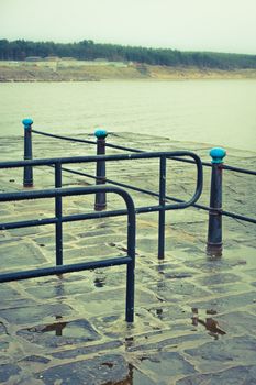 Vintage toned image of a wet seaside promenade