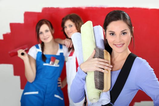 Three women home decorating