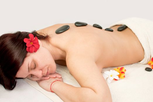 pretty female at spa center, stones relaxing therapy