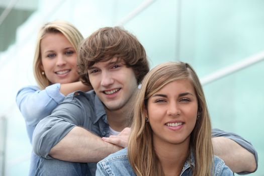 three students sitting on stairs