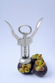 corkscrew drill into the mangosteen isolated on white background