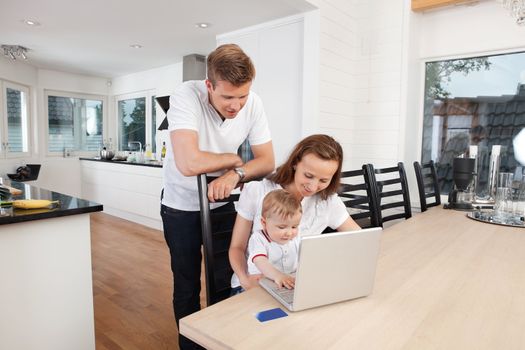 Family working on laptop together at home