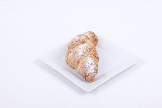 fresh almond croissant isolated on a white  background