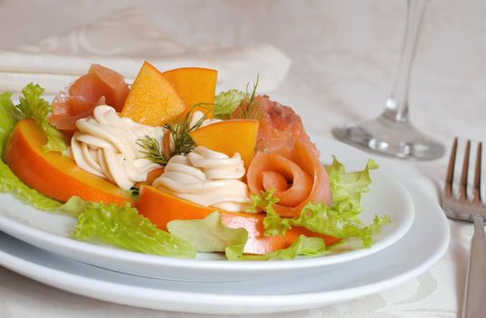 Salmon salad with persimmon and cream cheese closeup