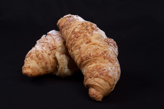 fresh croissant isolated on a black background