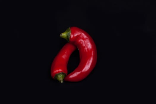 Red hot chilli peppers  isolated on black.