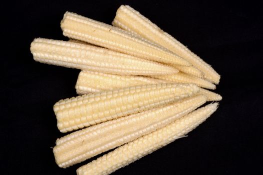 Baby corn  isolated on black background