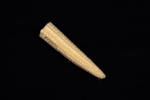 Baby corn  isolated on black background