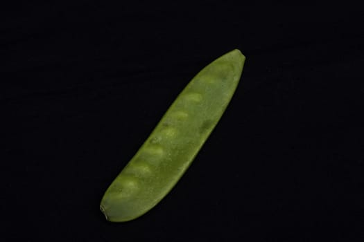 Mangetout Peas isolated on black background