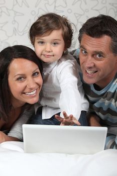 Family laying with laptop