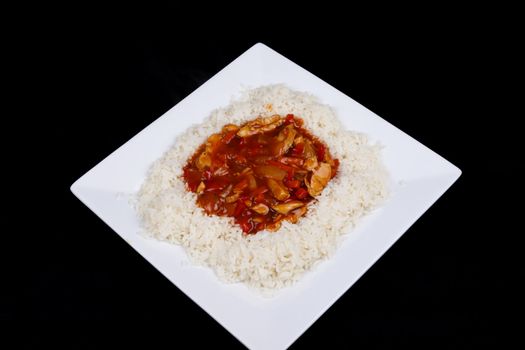 Closeup photo of chinese sweet and sour chicken with rice.