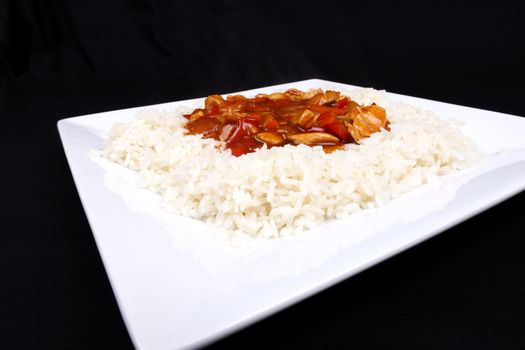 Closeup photo of chinese sweet and sour chicken with rice.