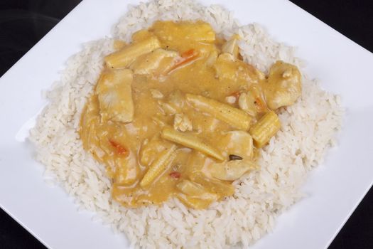diced chicken in coconut curry sauce served with rice
