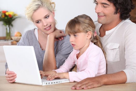 Parents with daughter and computer