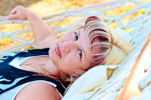 Portrait of elderly woman resting in a hammock