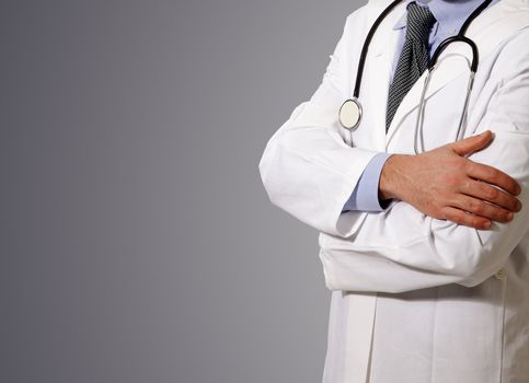 Doctor with a stethoscope at neck, grey background