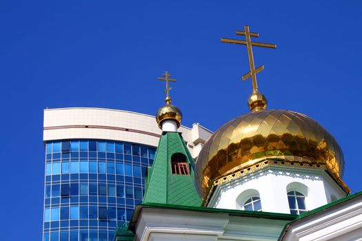 Church cupola against the modern building