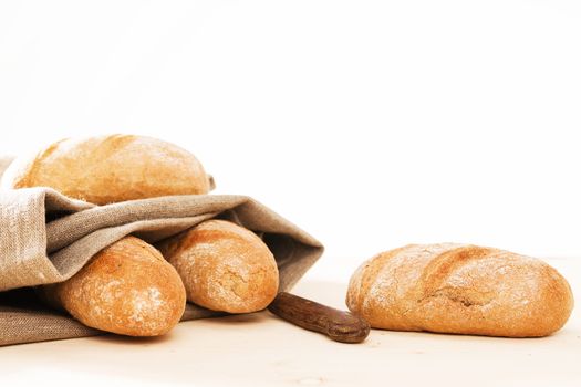 rye buns with a linen textile and a knife