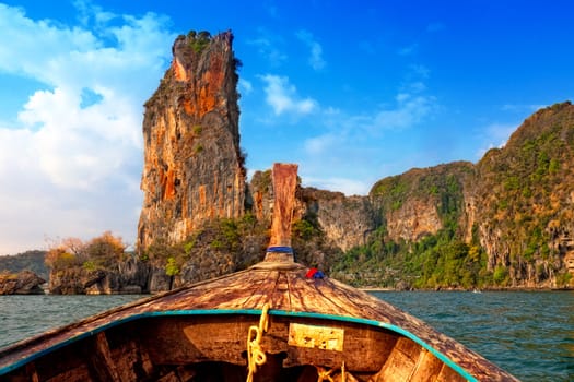 Longtail floats by rocks in the Andaman Sea