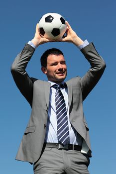 coach with ball in a park in summer