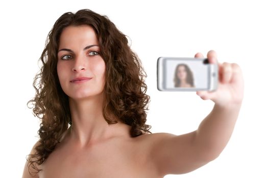 Young woman taking a picture of herself with a cell phone, isolated in a white background